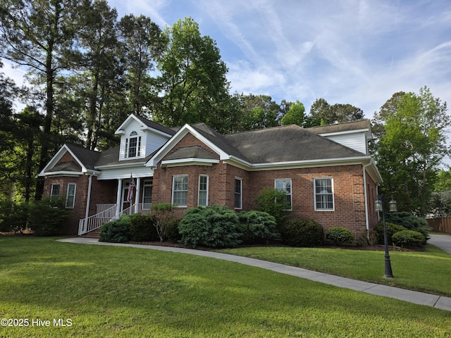 219 Drake Lndg, New Bern, NC 28560 - view of front of house with a porch, brick siding, and a front lawn