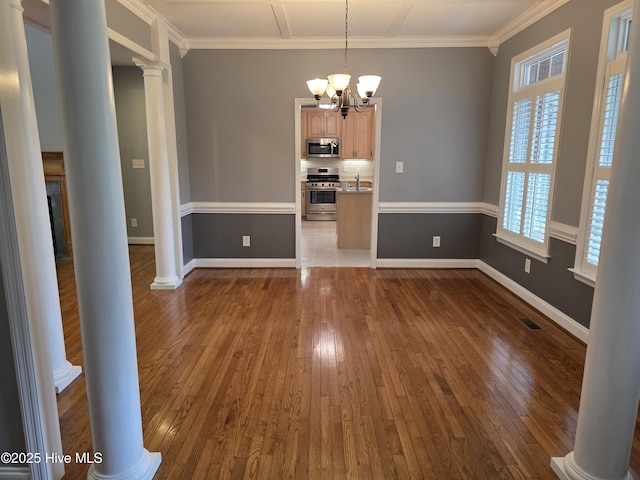 219 Drake Lndg, New Bern, NC 28560 - unfurnished dining area with ornate columns, a notable chandelier, crown molding, visible vents, and dark wood-style floors