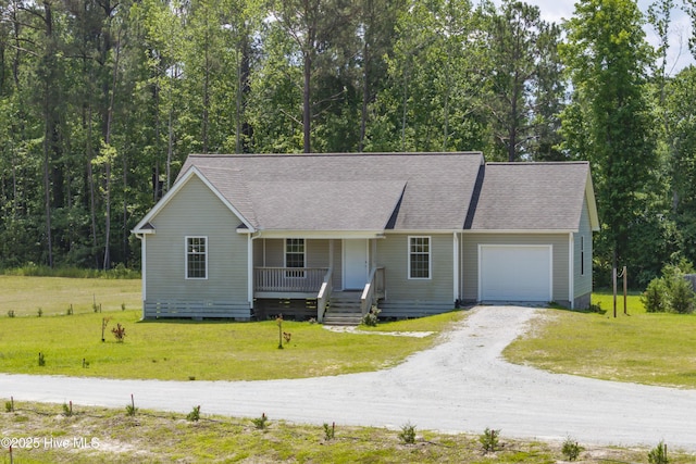 1406 Silverbrook Rd, Oriental, NC 28571 - view of front of property featuring covered porch, dirt driveway, a garage, a front lawn, and roof with shingles