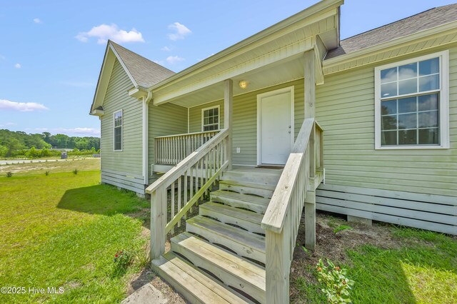 1406 Silverbrook Rd, Oriental, NC 28571 - doorway to property with a shingled roof, a lawn, and a porch