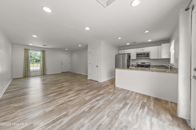 1406 Silverbrook Rd, Oriental, NC 28571 - kitchen with stainless steel appliances, a sink, recessed lighting, baseboards, and light wood-style flooring
