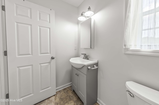 1406 Silverbrook Rd, Oriental, NC 28571 - half bath featuring vanity, baseboards, healthy amount of natural light, and toilet