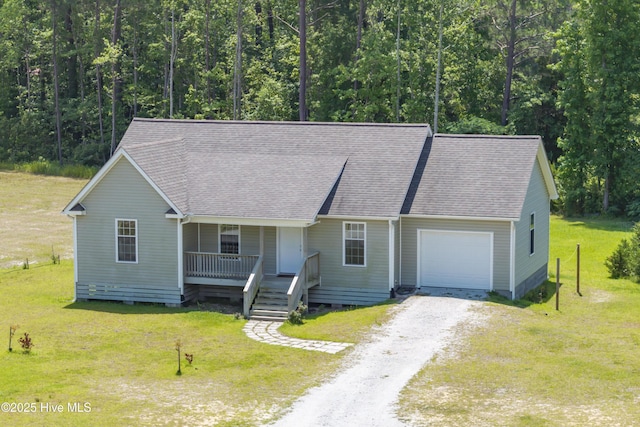 1406 Silverbrook Rd, Oriental, NC 28571 - view of front facade with an attached garage, covered porch, dirt driveway, a front yard, and roof with shingles