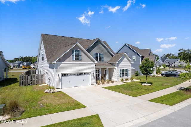 view of front of property with a garage, fence, a front lawn, board and batten siding, and driveway