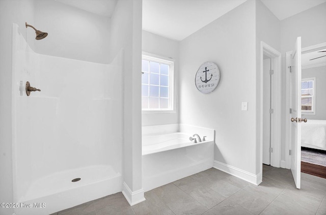 bathroom featuring baseboards, a wealth of natural light, and walk in shower