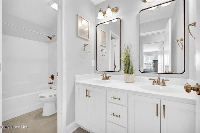 full bath with toilet, tile patterned flooring, double vanity, and a sink