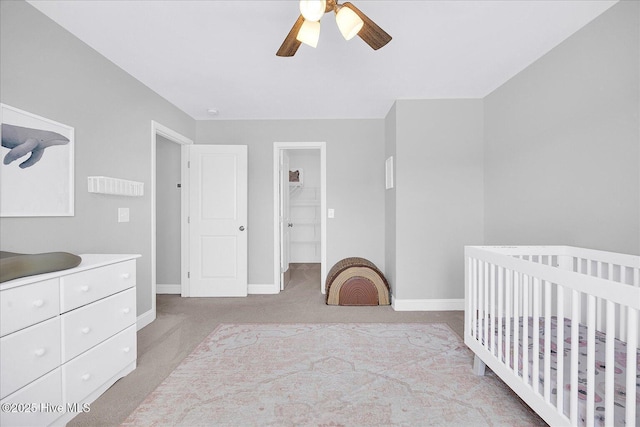 carpeted bedroom with baseboards and ceiling fan
