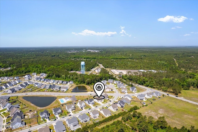 bird's eye view featuring a wooded view and a residential view