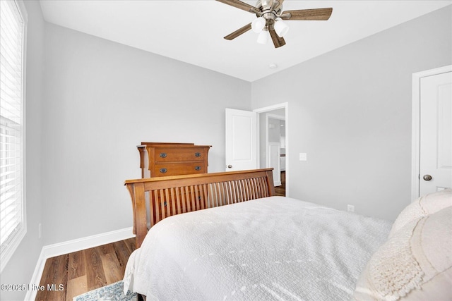 bedroom featuring ceiling fan, baseboards, and wood finished floors
