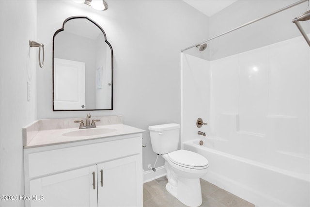 bathroom with toilet, baseboards, vanity, and washtub / shower combination