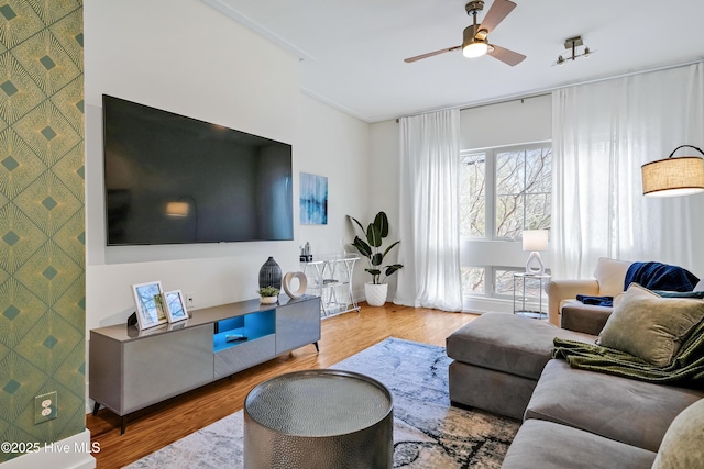living area featuring ceiling fan and wood finished floors