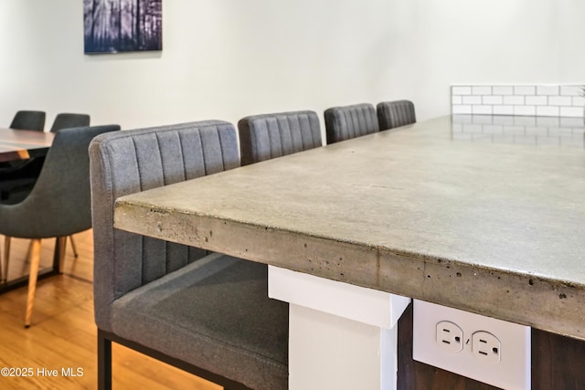 dining space with wood finished floors