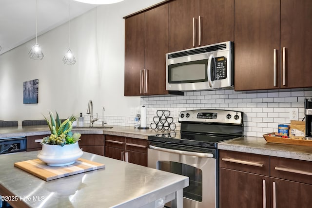 kitchen with appliances with stainless steel finishes, a sink, decorative backsplash, and dark brown cabinets