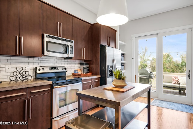 kitchen featuring appliances with stainless steel finishes, tasteful backsplash, and dark brown cabinetry