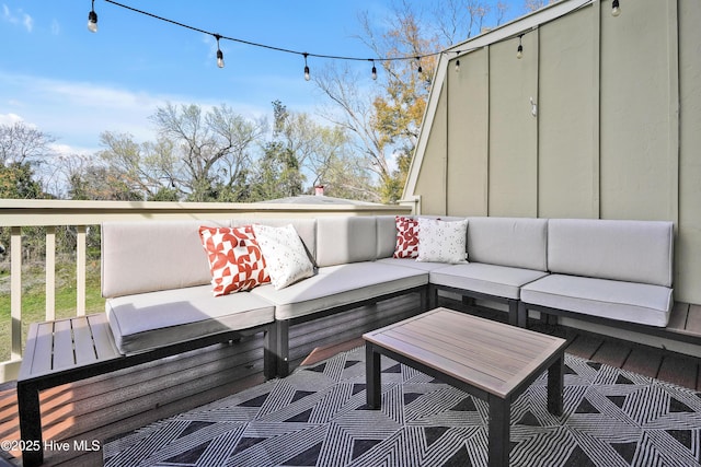 wooden deck with an outdoor living space