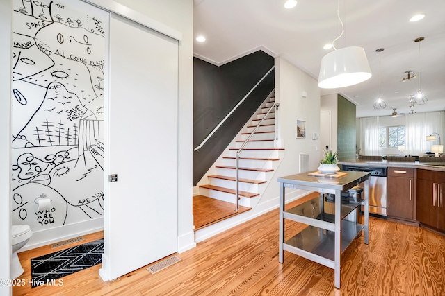 kitchen featuring dishwasher, light wood-style flooring, baseboards, pendant lighting, and recessed lighting