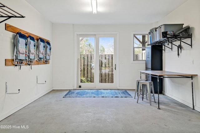doorway to outside featuring concrete floors and healthy amount of natural light