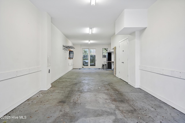 garage with french doors and baseboards