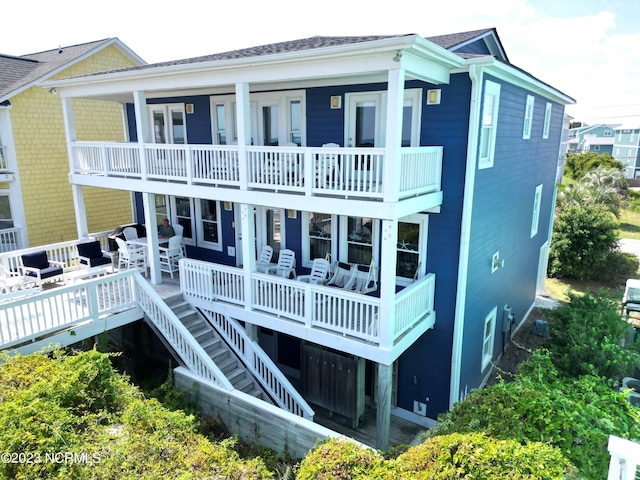 back of property with a balcony