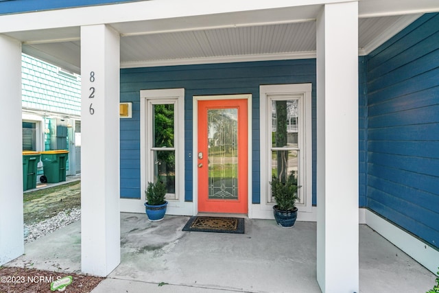 doorway to property featuring covered porch