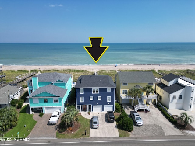 birds eye view of property with a beach view and a water view