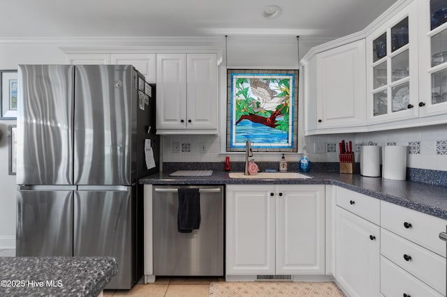 826 Fort Fisher Blvd N, Kure Beach, NC 28449 - kitchen with appliances with stainless steel finishes, a sink, white cabinets, and decorative backsplash