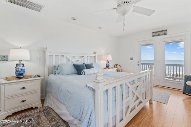 826 Fort Fisher Blvd N, Kure Beach, NC 28449 - bedroom featuring access to exterior, light wood-type flooring, a water view, ceiling fan, and recessed lighting