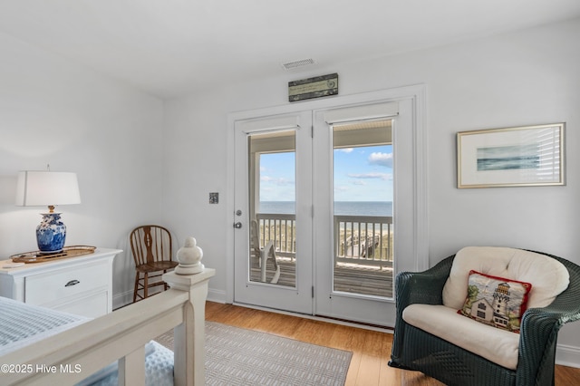 826 Fort Fisher Blvd N, Kure Beach, NC 28449 - bedroom with access to exterior, light wood-type flooring, and a water view