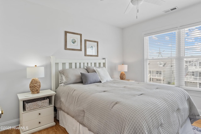 826 Fort Fisher Blvd N, Kure Beach, NC 28449 - bedroom with wood finished floors, baseboards, and a ceiling fan