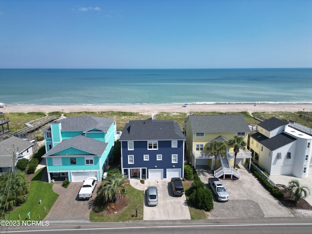 birds eye view of property featuring a water view and a beach view