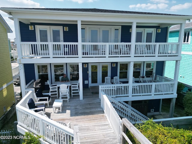 back of house featuring a balcony