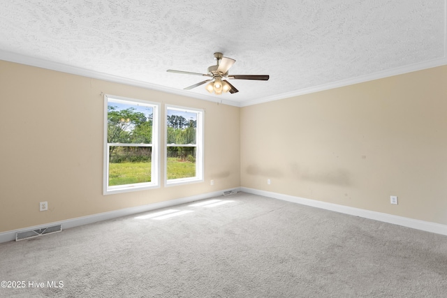 empty room with ceiling fan, a textured ceiling, crown molding, and visible vents