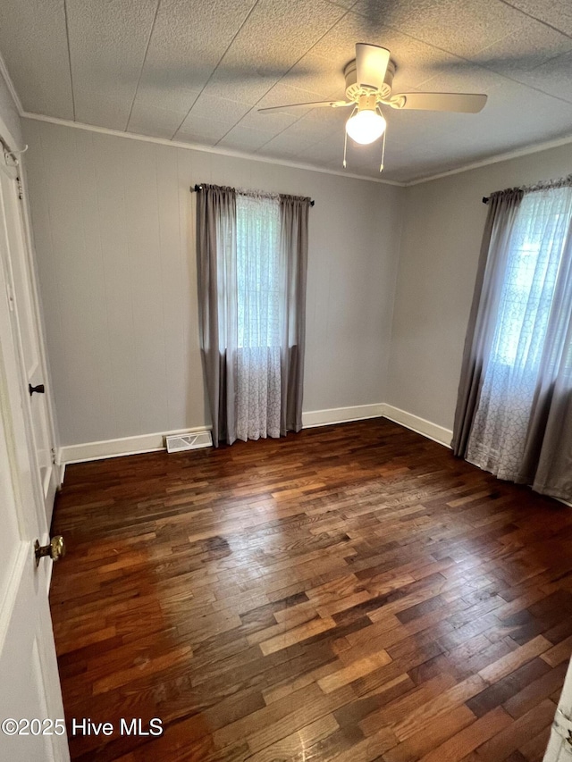 214 S Graham St, Wallace, NC 28466 - spare room with dark wood finished floors, ornamental molding, a ceiling fan, and baseboards