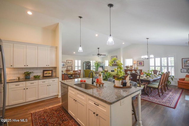 kitchen featuring dishwasher, a sink, white cabinetry, open floor plan, and dark wood-type flooring