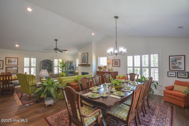dining area featuring recessed lighting, visible vents, ceiling fan with notable chandelier, a brick fireplace, and dark wood-type flooring