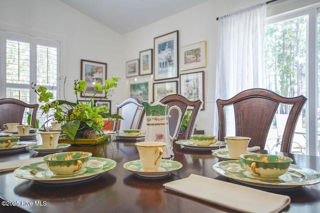 dining area featuring vaulted ceiling