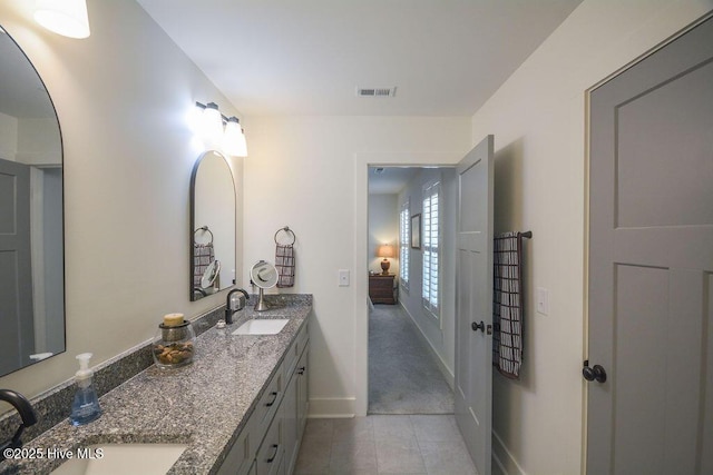 bathroom with tile patterned floors, visible vents, a sink, and double vanity