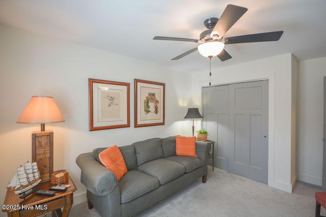 living room with a ceiling fan, carpet flooring, and baseboards