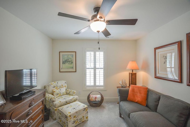 living room with ceiling fan, carpet, and baseboards