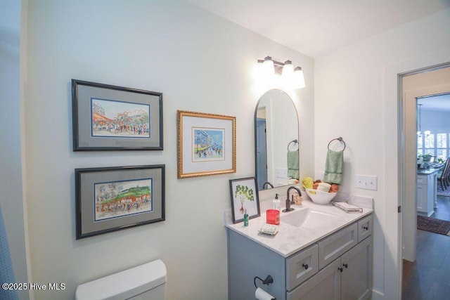 half bathroom featuring toilet and vanity