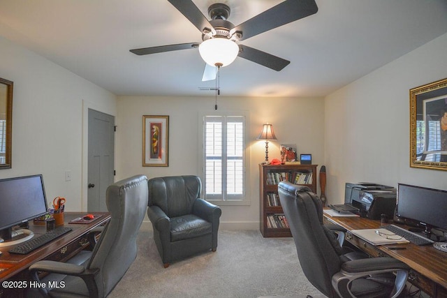 office with carpet, visible vents, and a ceiling fan