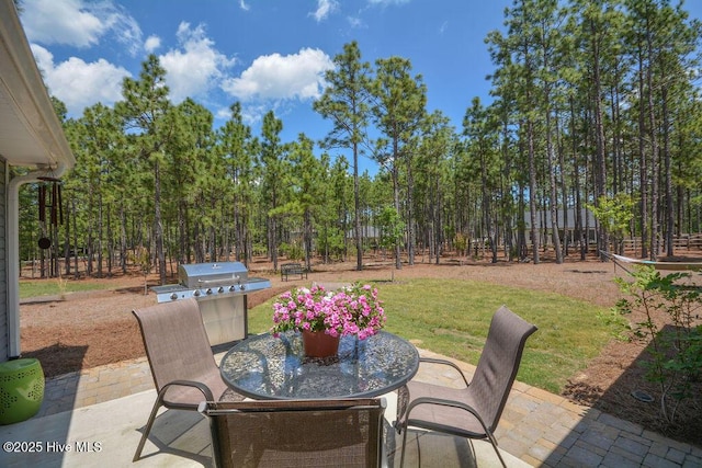 view of patio with outdoor dining area and a grill