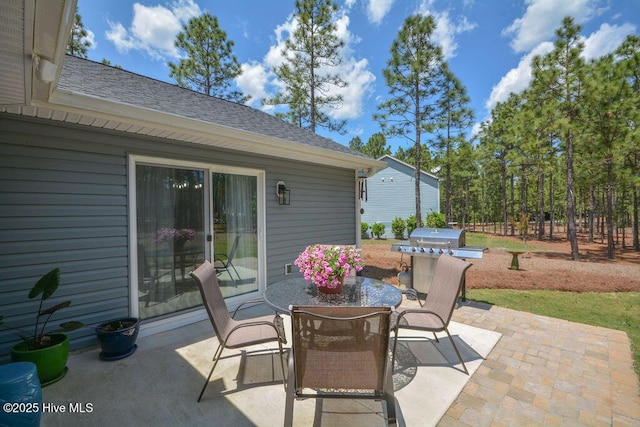 view of patio featuring outdoor dining area and a grill