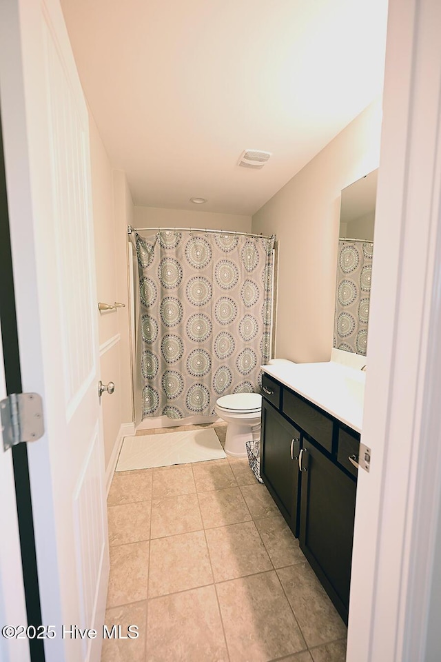911 Needlerush Rd, Sneads Ferry, NC 28460 - full bathroom featuring toilet, vanity, tile patterned flooring, and a shower with shower curtain