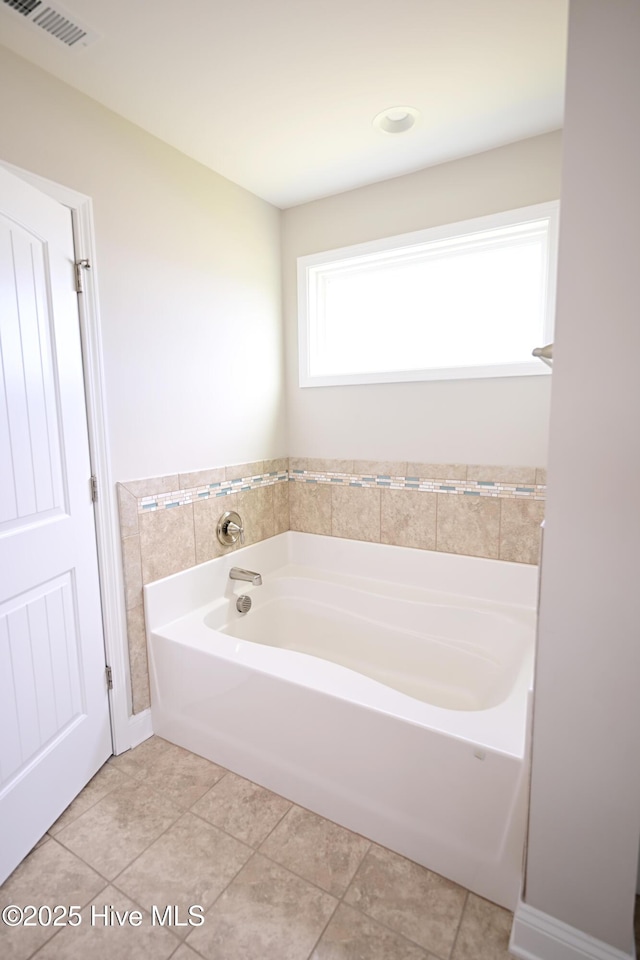 911 Needlerush Rd, Sneads Ferry, NC 28460 - bathroom featuring a garden tub and tile patterned flooring