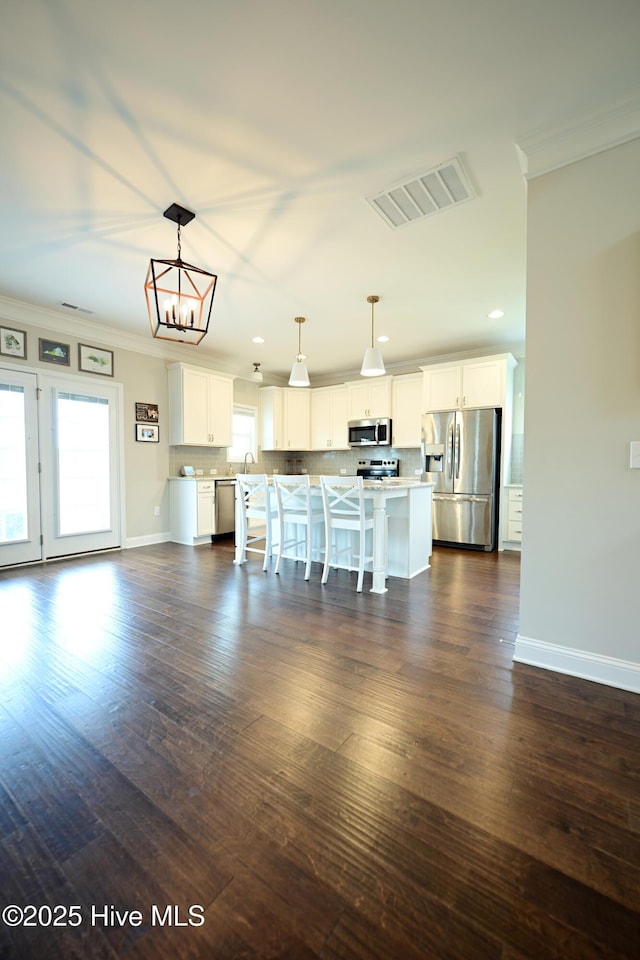 911 Needlerush Rd, Sneads Ferry, NC 28460 - unfurnished living room featuring crown molding, baseboards, dark wood-style flooring, a sink, and recessed lighting