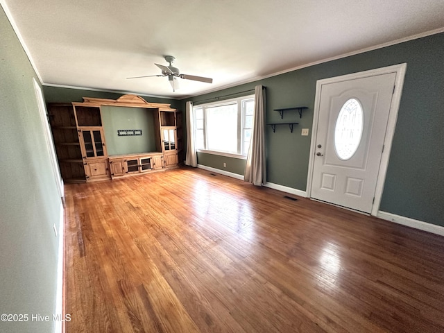 706 E Country Club Dr, Tarboro, NC 27886 - unfurnished living room featuring ceiling fan, crown molding, baseboards, and wood finished floors