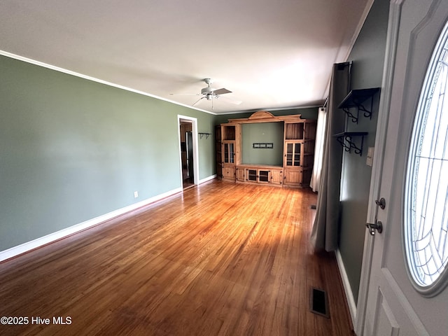706 E Country Club Dr, Tarboro, NC 27886 - unfurnished living room featuring baseboards, ornamental molding, visible vents, ceiling fan, and wood finished floors