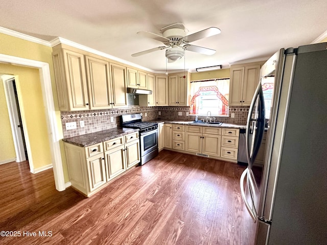 706 E Country Club Dr, Tarboro, NC 27886 - kitchen with dark wood-style flooring, ornamental molding, a sink, appliances with stainless steel finishes, and cream cabinets