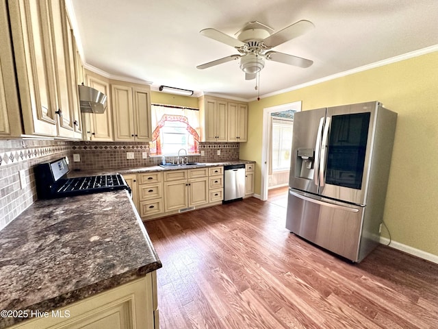 706 E Country Club Dr, Tarboro, NC 27886 - kitchen with a sink, extractor fan, stainless steel appliances, and cream cabinetry